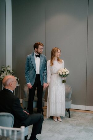 Bride and groom holding hands at wedding ceremony.