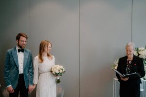 Wedding ceremony with smiling couple and officiant