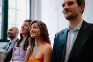 Smiling group listening in a bright room.