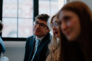 Group of people attentively listening indoors.