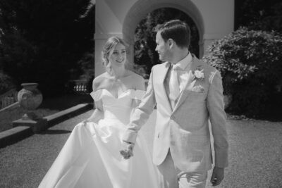 Bride and groom holding hands outdoors