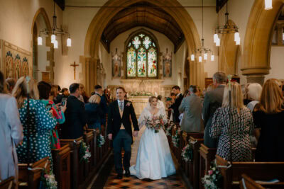 Bride and groom exiting church wedding ceremony.