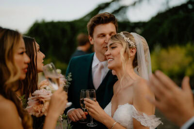 Bride and groom celebrating with friends outdoors.