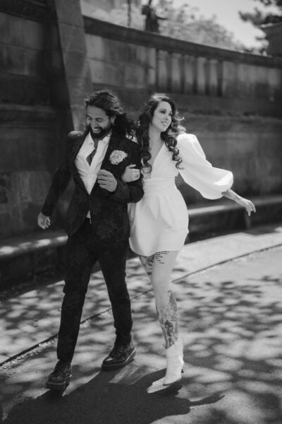 Happy couple walking arm in arm outdoors.