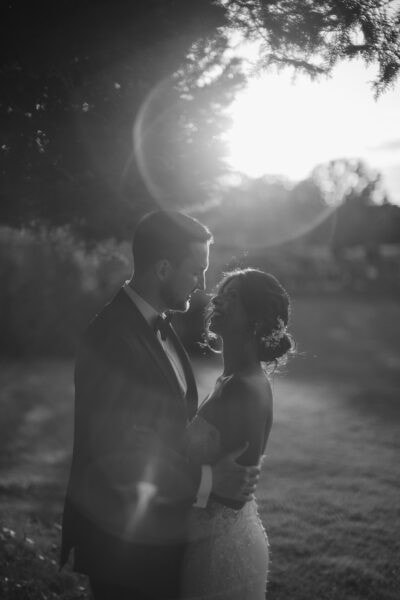 Couple embracing outdoors at sunset.