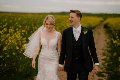 Happy couple walking in a flower field