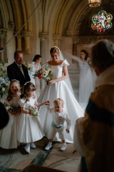 Bride with children at wedding ceremony indoors