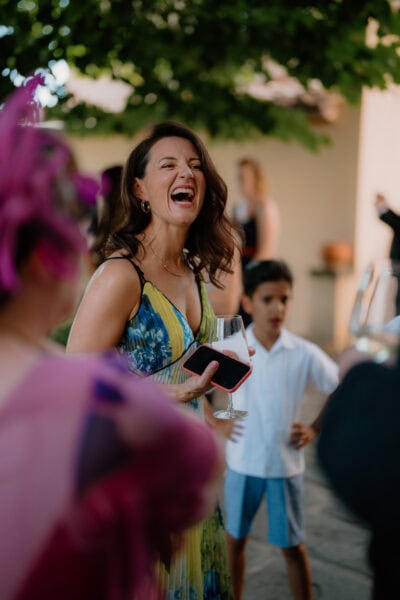 Woman laughing at outdoor gathering