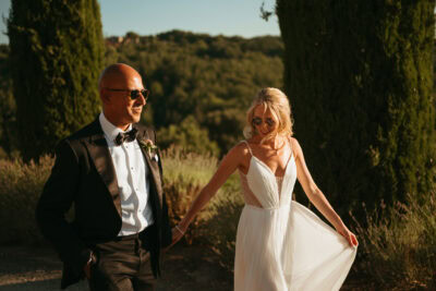 Couple in formal attire enjoying outdoor scenery.