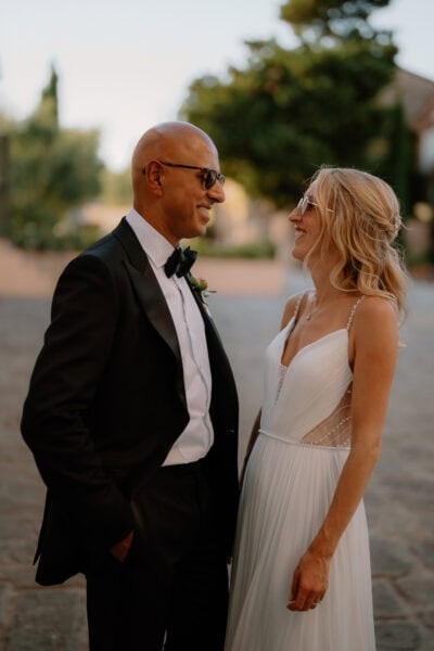 Elegant couple smiling at each other outdoors