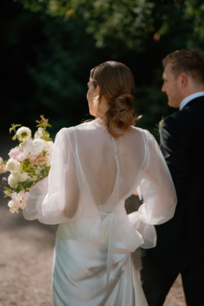 Bride and groom outdoors with bouquet