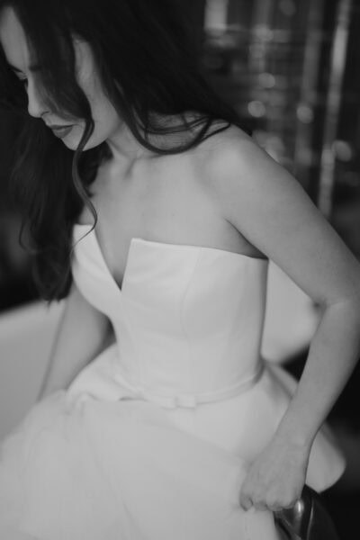 Black and white photo of woman in wedding dress.