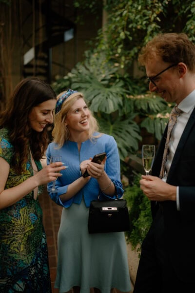 People chatting and laughing at a garden party.
