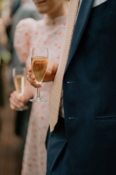 People holding champagne glasses at formal event