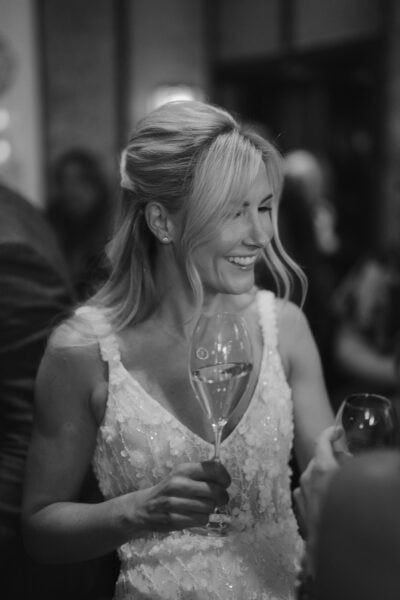 Smiling bride holding a glass at reception