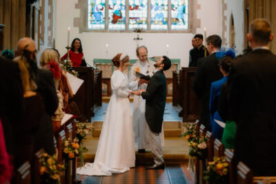 Bride and groom exchanging vows in church wedding.